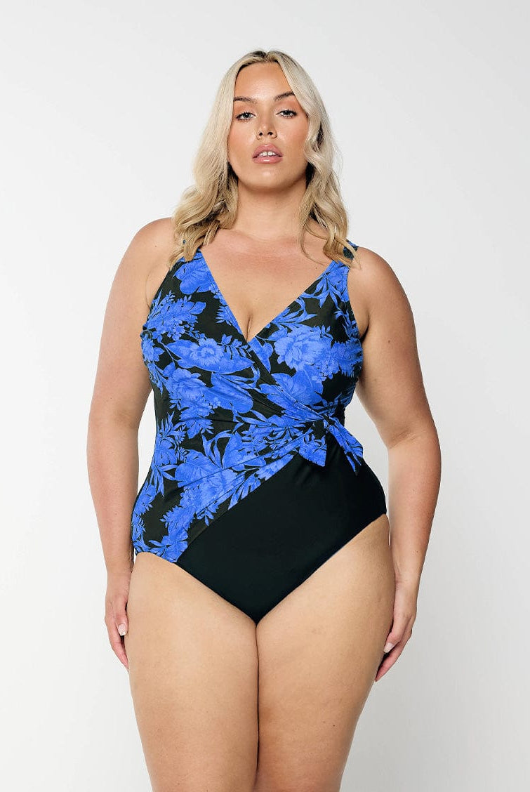 model wearing blue floral waist tie one piece