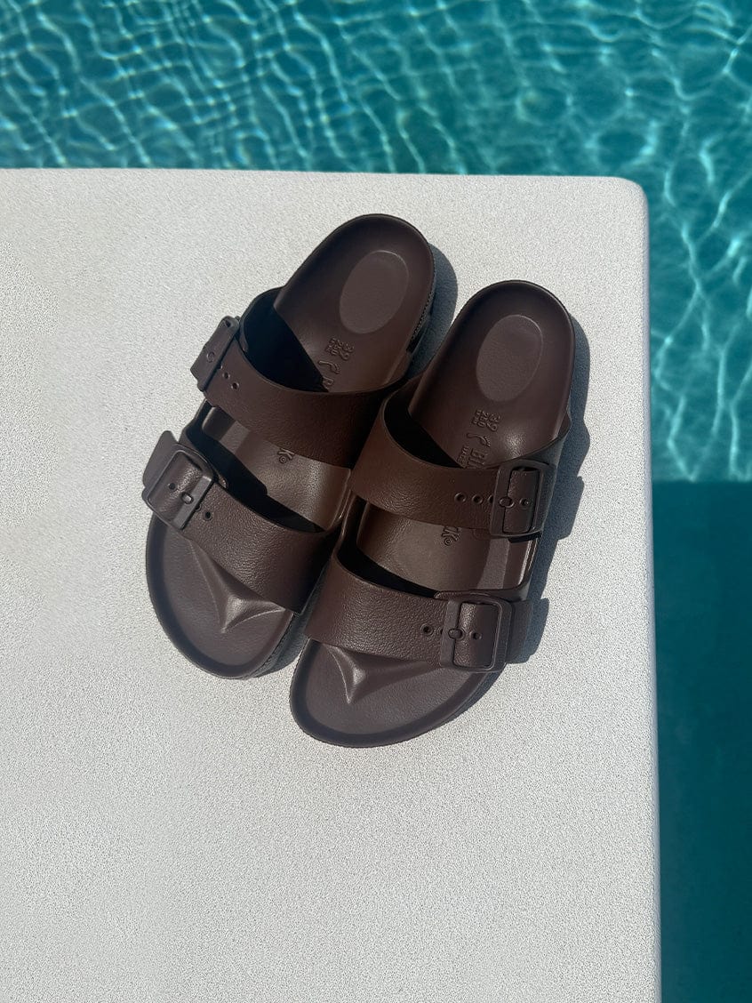 brown sandals on a diving board over pool