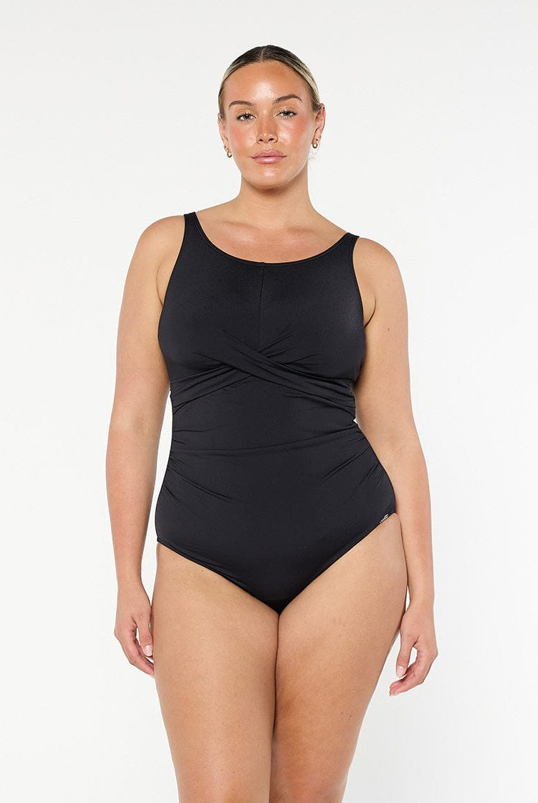 model wearing black high neck twist one piece