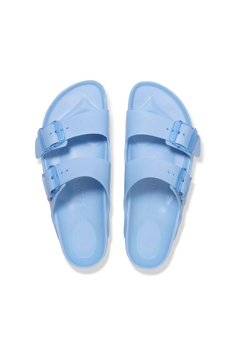 Pair of light blue sandals on a white background