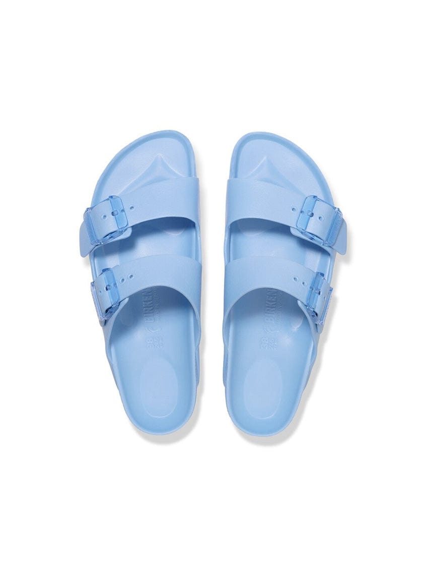 Pair of light blue sandals on a white background