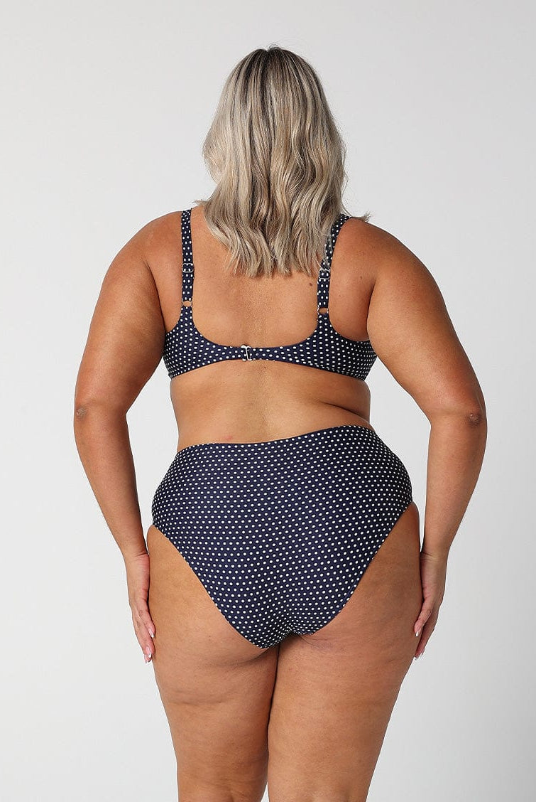 model showing cheeky cut of high rise navy dots bikini bottom