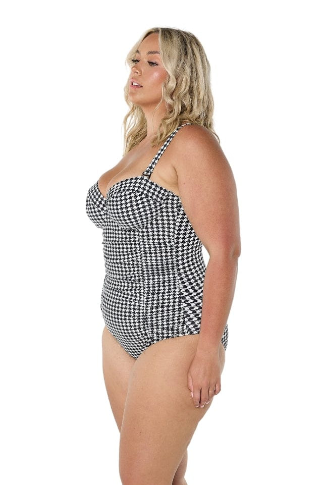 model wearing black and white print swimsuit