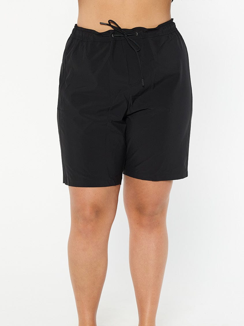 model wearing women's black board shorts
