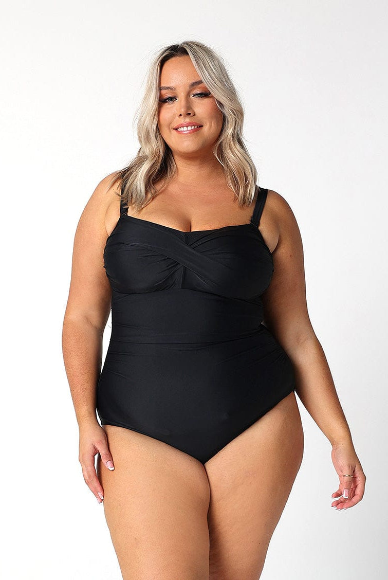 model wearing twist front bandeau one piece