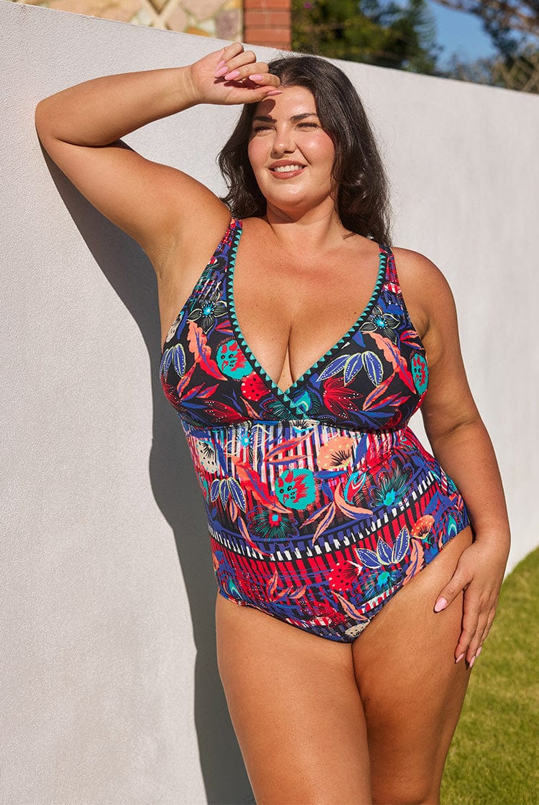 model wearing bright floral v neck swimsuit
