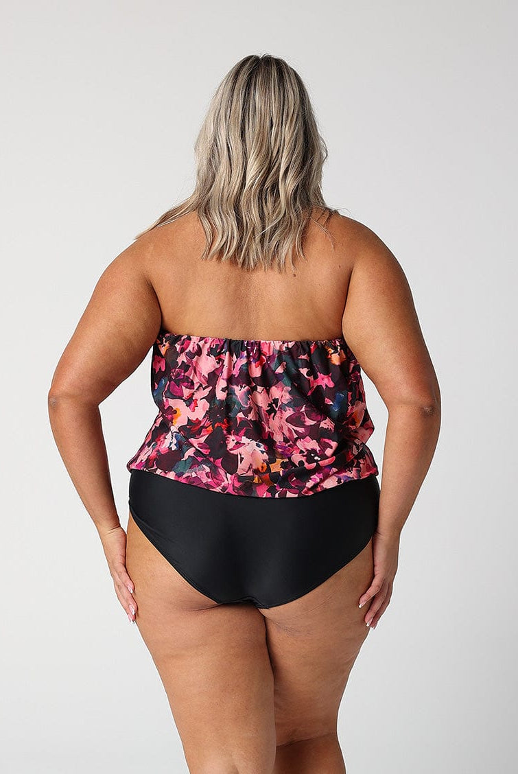 model showing back of pink floral strapless one piece
