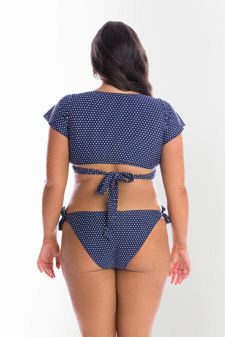 model showing back of navy dots tie side bikini pant
