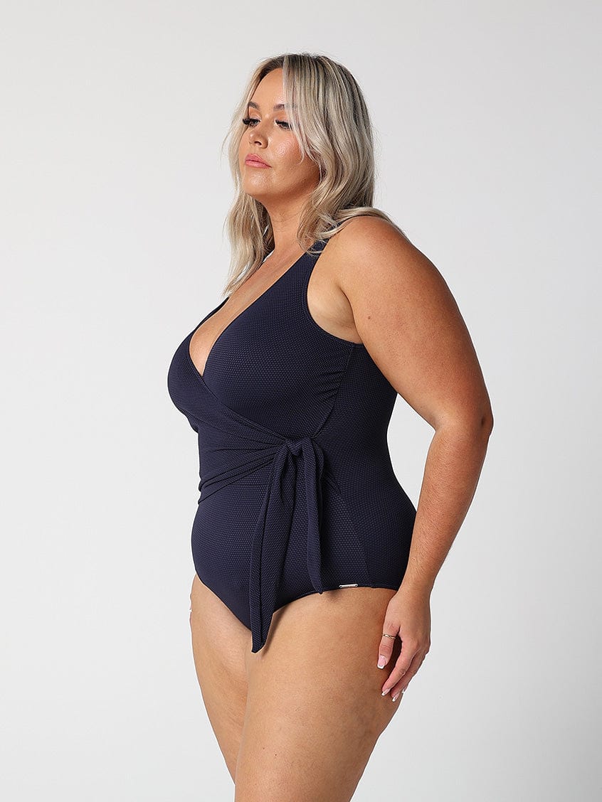 model showing side of navy waist tie one piece