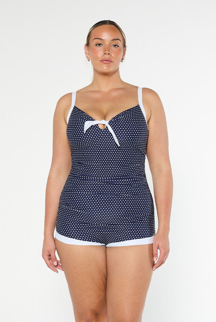 model wearing navy and white dots boyleg one piece