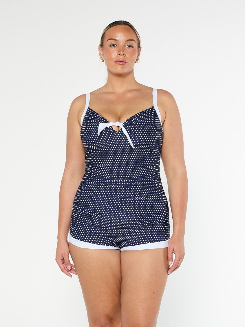 model wearing navy and white dots boyleg one piece