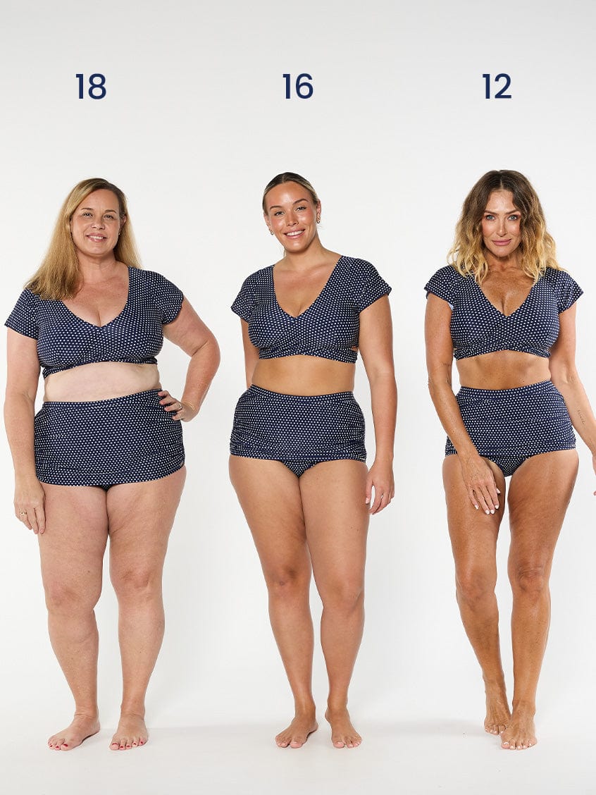 three models wearing navy and white dots wrap crop top and matching skirted pant