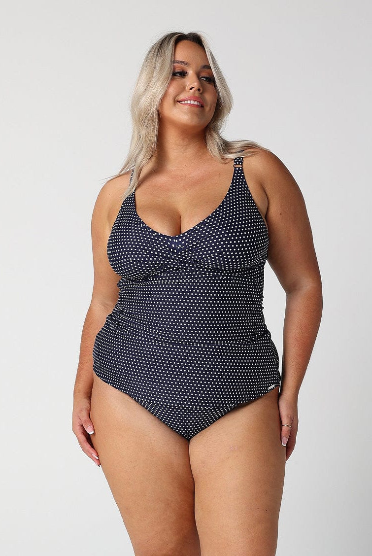 model wearing navy dots twist front tankini