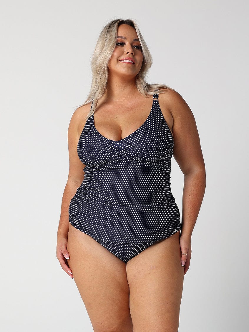 model wearing navy dots twist front tankini