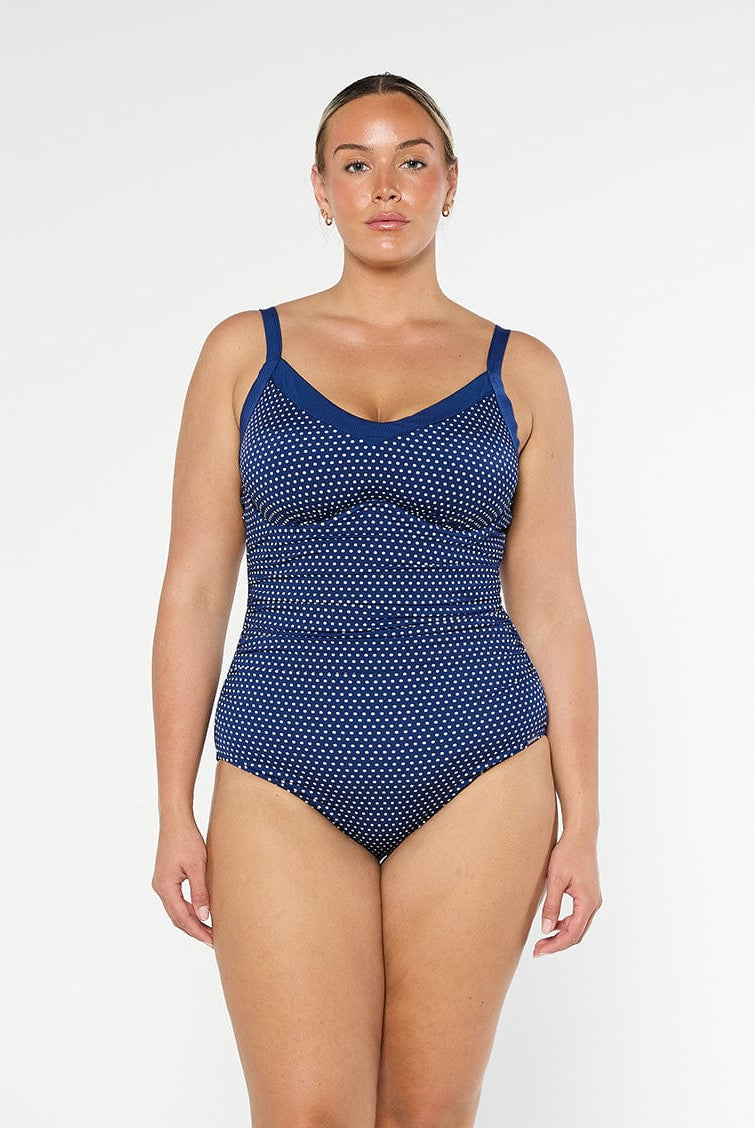 model wearing navy and white dots underwire swimsuit