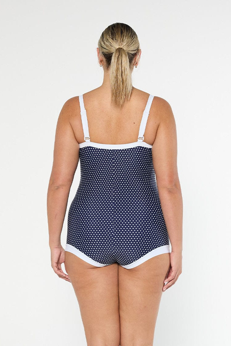 model showing back of navy polka dot boyleg one piece