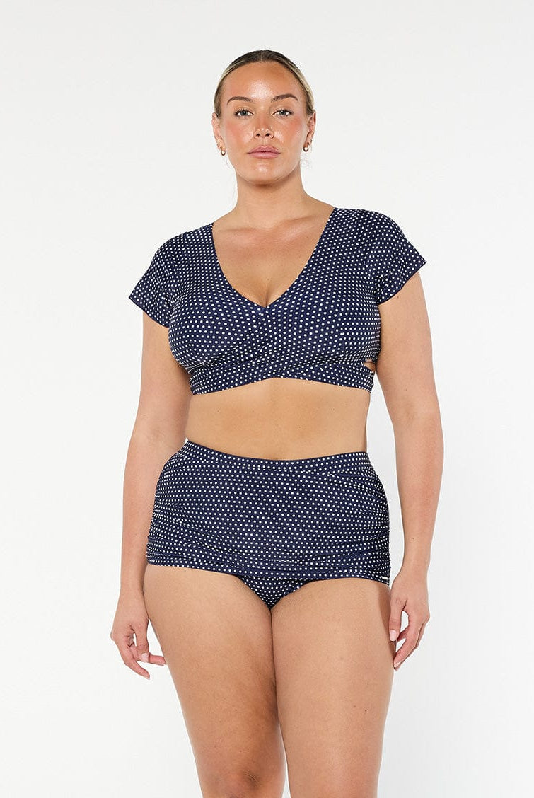 model wearing navy and white dots wrap crop top