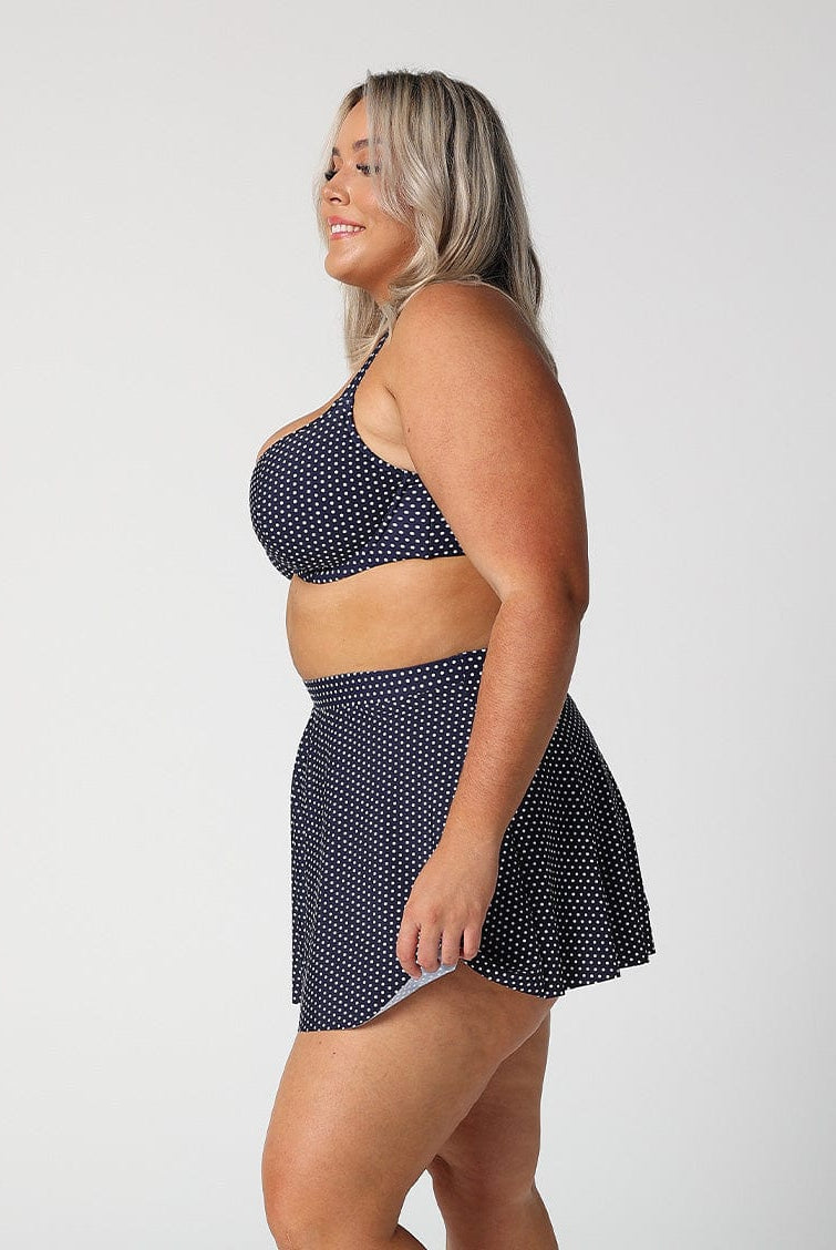 model wears navy polka dot skater skirt