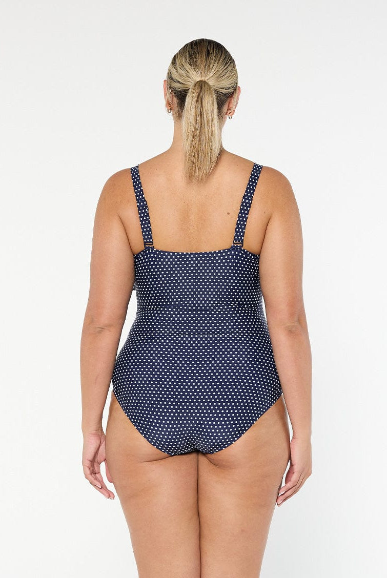 model showing back of navy and white dots women's one piece