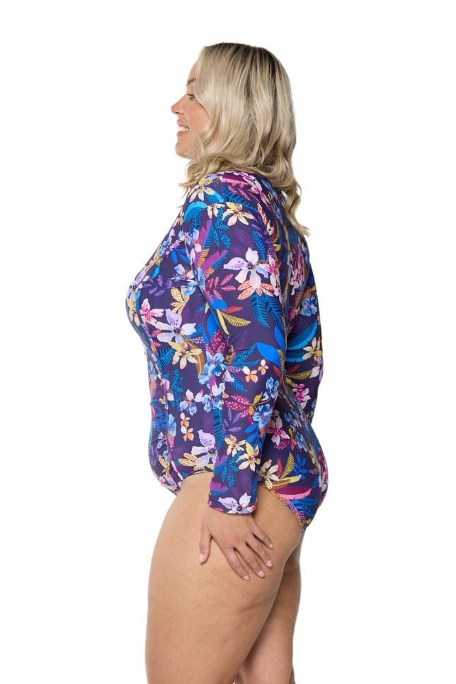 model showing side of navy tropical print long sleeve swimsuit