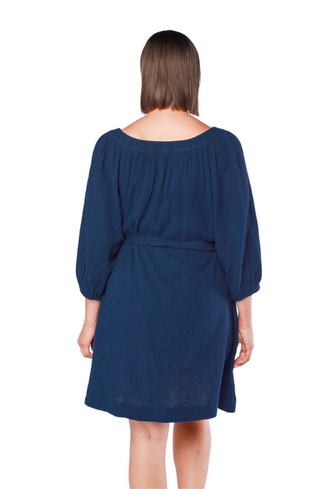 back of model wearing navy cheesecloth dress with waist tie