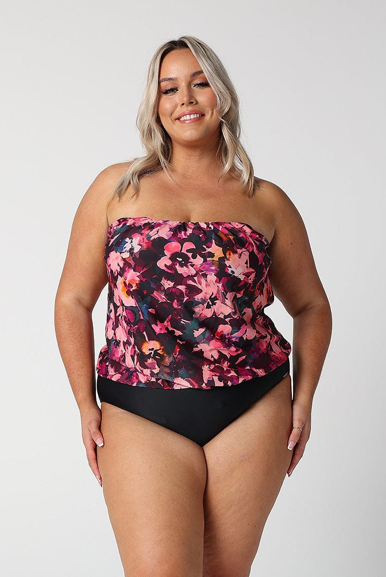 model wearing pink and plum coloured floral strapless swimsuit