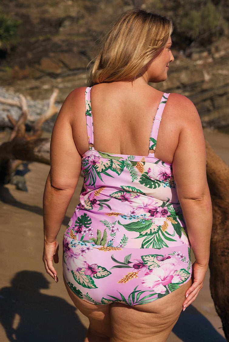 model wearing full coverage pink floral bottom with matching tankini at beach