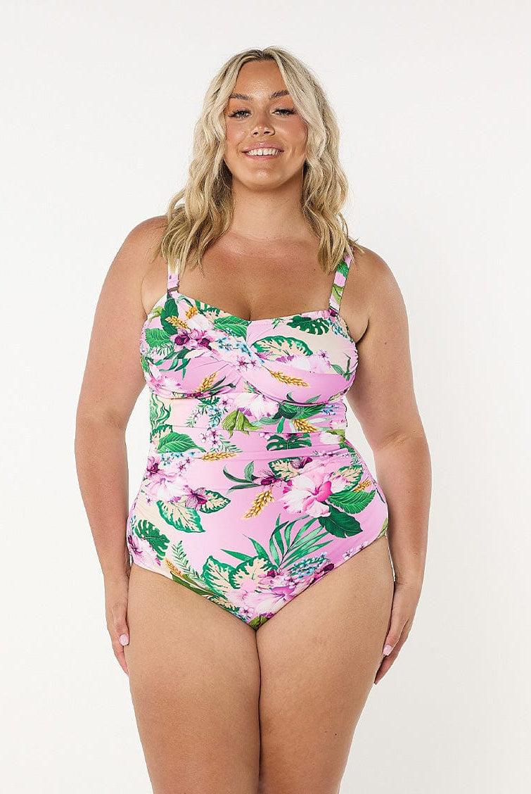 model wearing light pink floral women's swimsuit