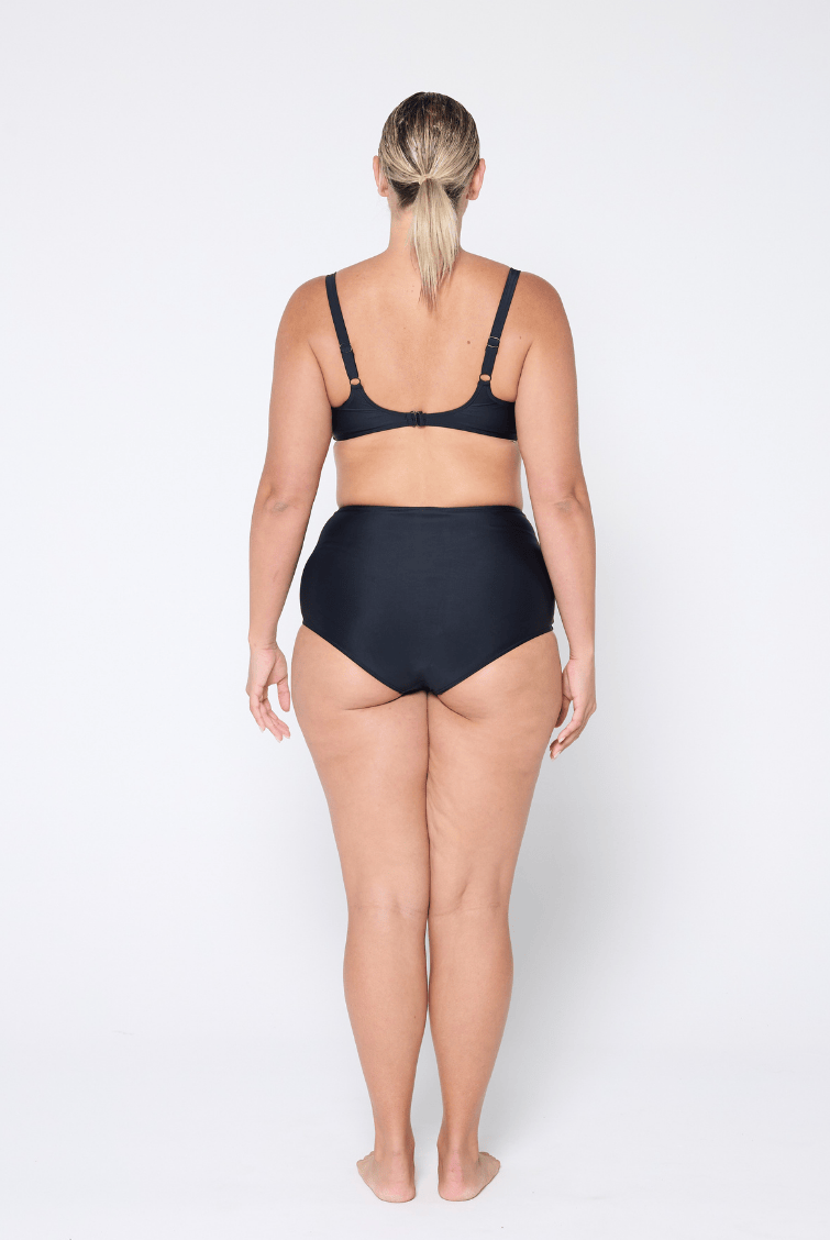 Person wearing a black bikini set on a white background