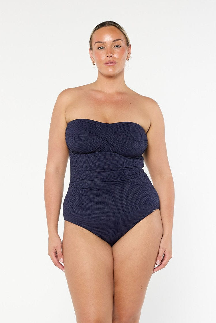 model wearing navy textured bandeau swimsuit
