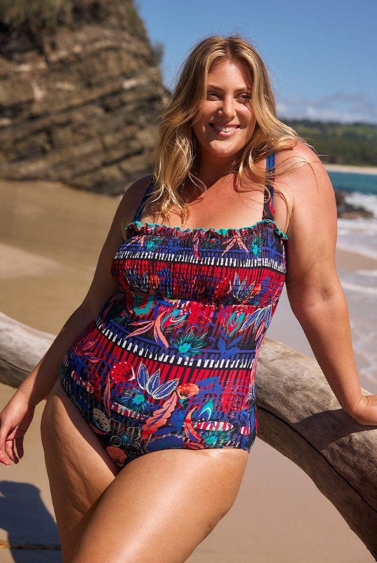 model wearing multicoloured shirred one piece at beach