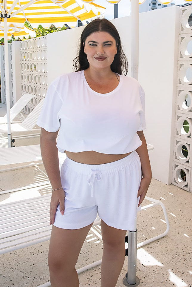 model wearing white terry towelling shorts with drawstring