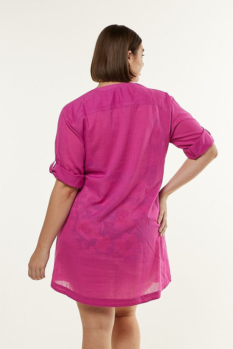 Back of model wearing pink beach overshirt