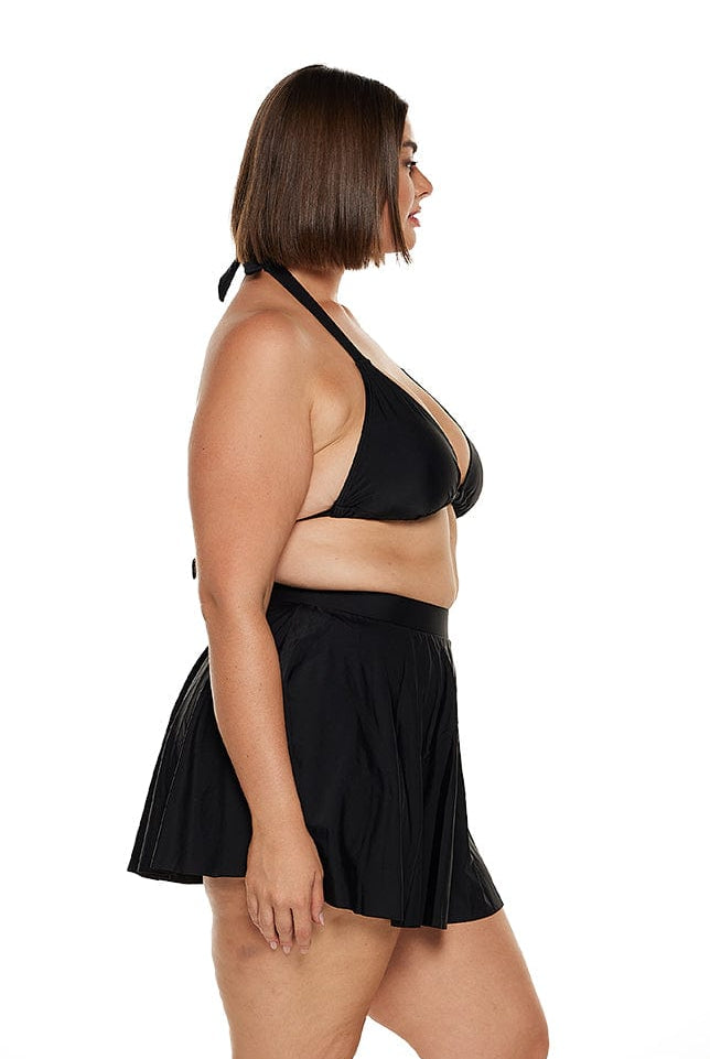 Brunette model wears high waisted retro style swim skirt in black