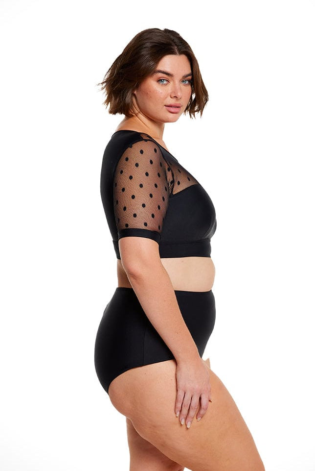 Brunette women wears mesh polkadot short sleeve cropped bikini top