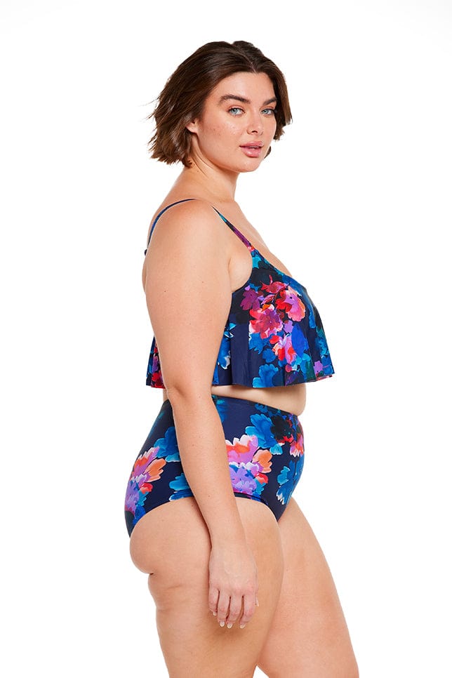 Brunette model shows side of navy floral bikini set