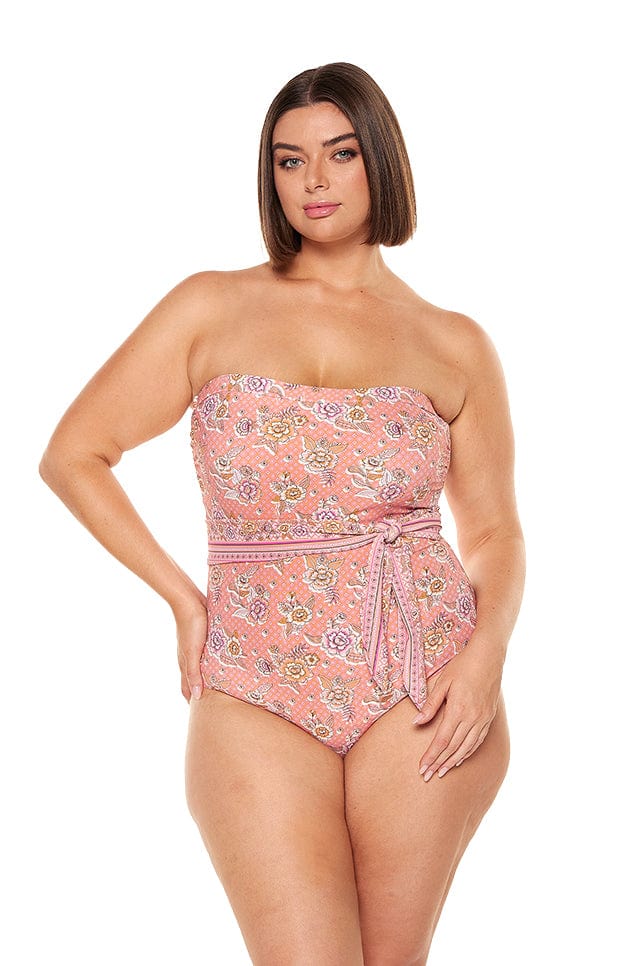 brunette model wears flattering pink floral underwire one piece with removable straps and tie side detail