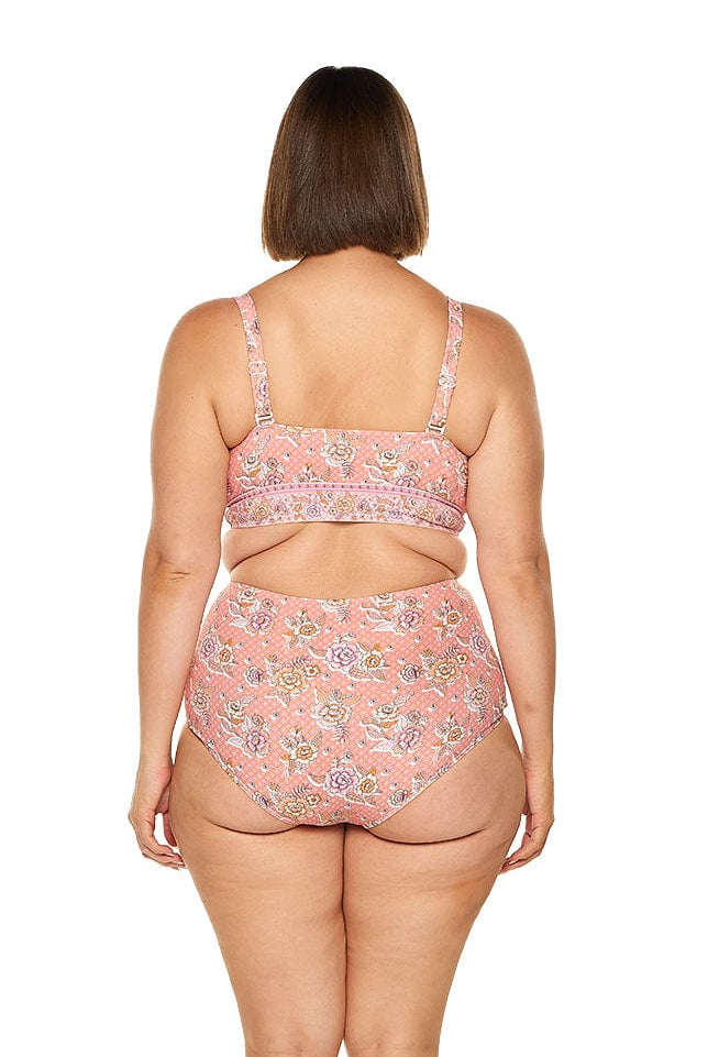 Brunette model wears flattering pink floral high waisted bikini bottoms