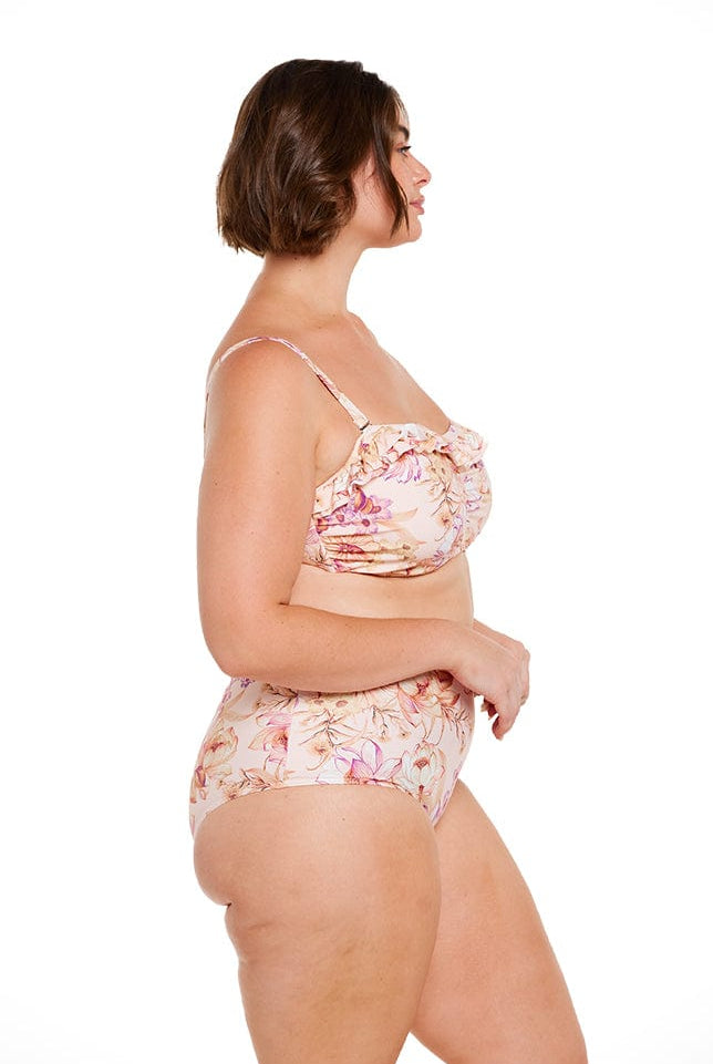 Brunette model wears pink and gold floral high waisted swim pant