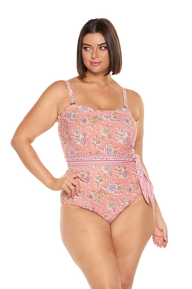 Brunette model wearing salmon pink floral underwire one piece with removable straps and removable belt