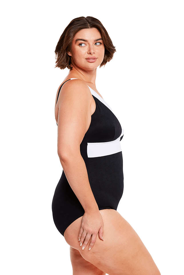 brunette model wears flattering v neck one piece swimsuit