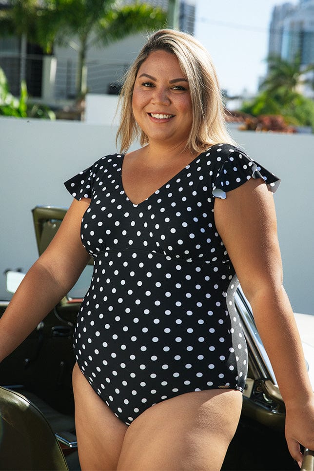 Model wearing black and white dots v neck frill sleeve one piece