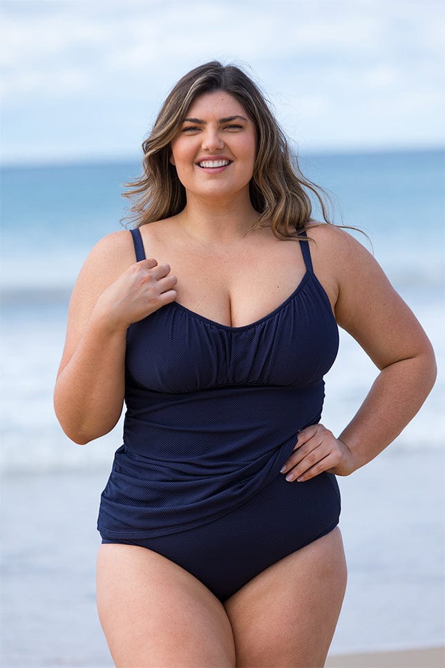 Model wearing Navy textured tankini top with underwire support at the beach
