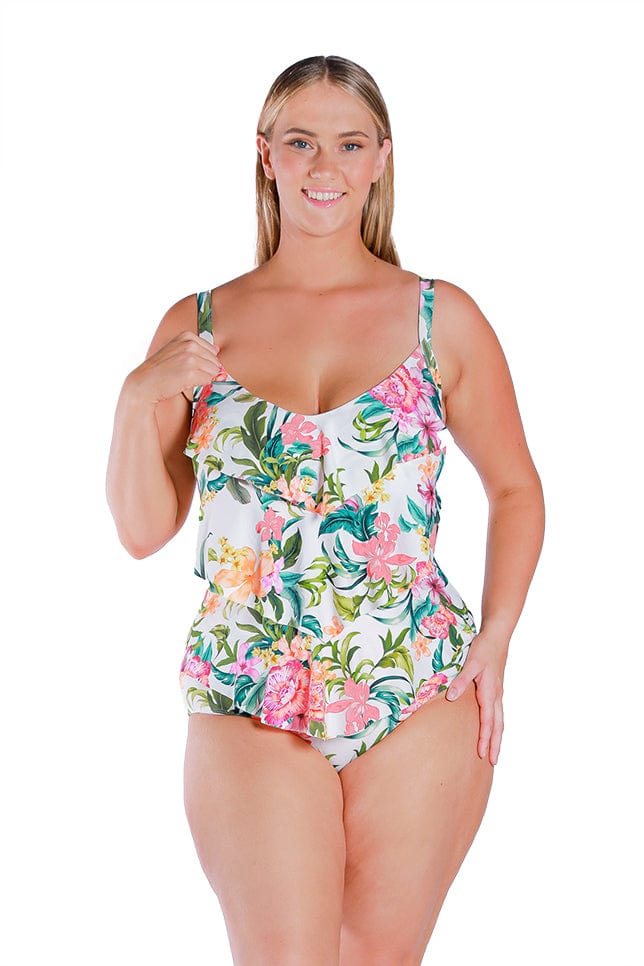 blonde plus size model wears white one piece with 3 tier ruffle details for stomach control