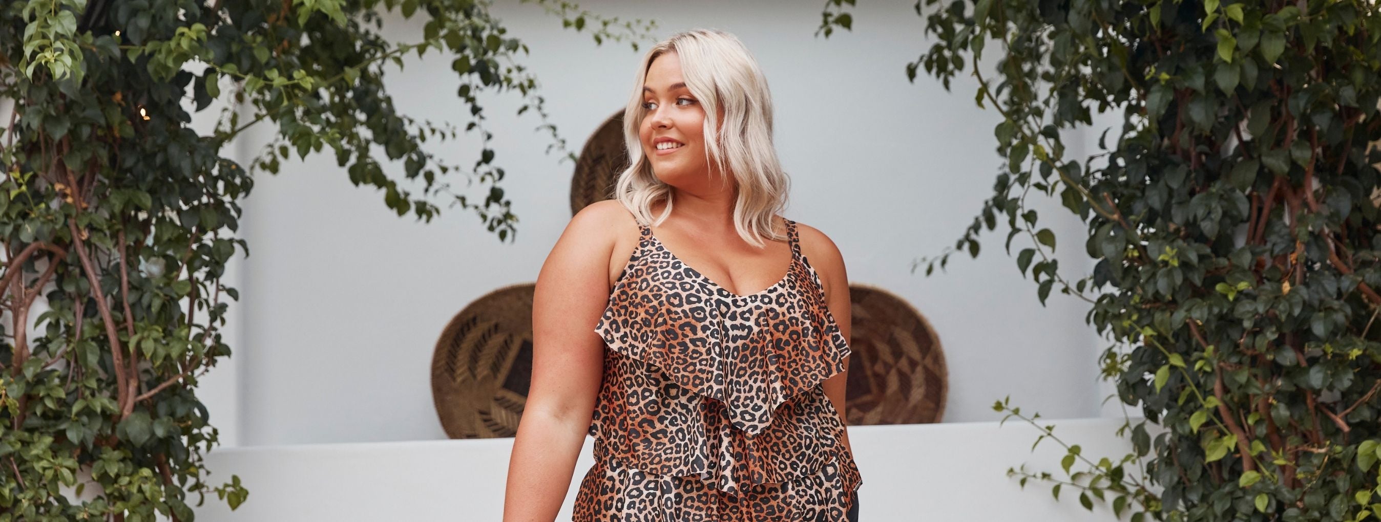 Blonde woman wears Leopard print 3 tier tankini top and black high waisted pant