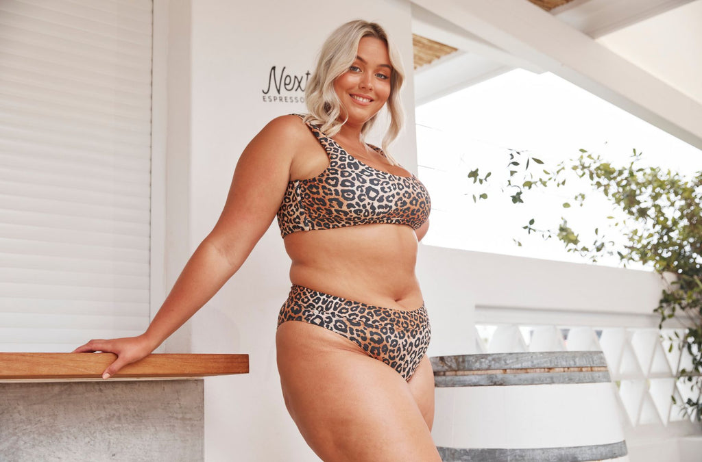 woman with blonde hair wears leopard bikini with high cut pant