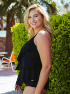 Side profile of model in a black 3 tiered tankini top 