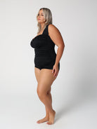 Woman wearing a black swimsuit on a white background