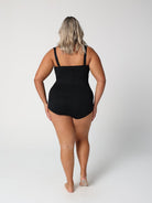 Person wearing a black swimsuit on a white background