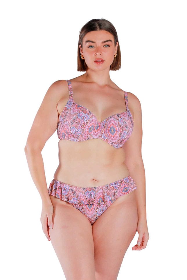 Model wearing pink and red toned frill top bikini pants